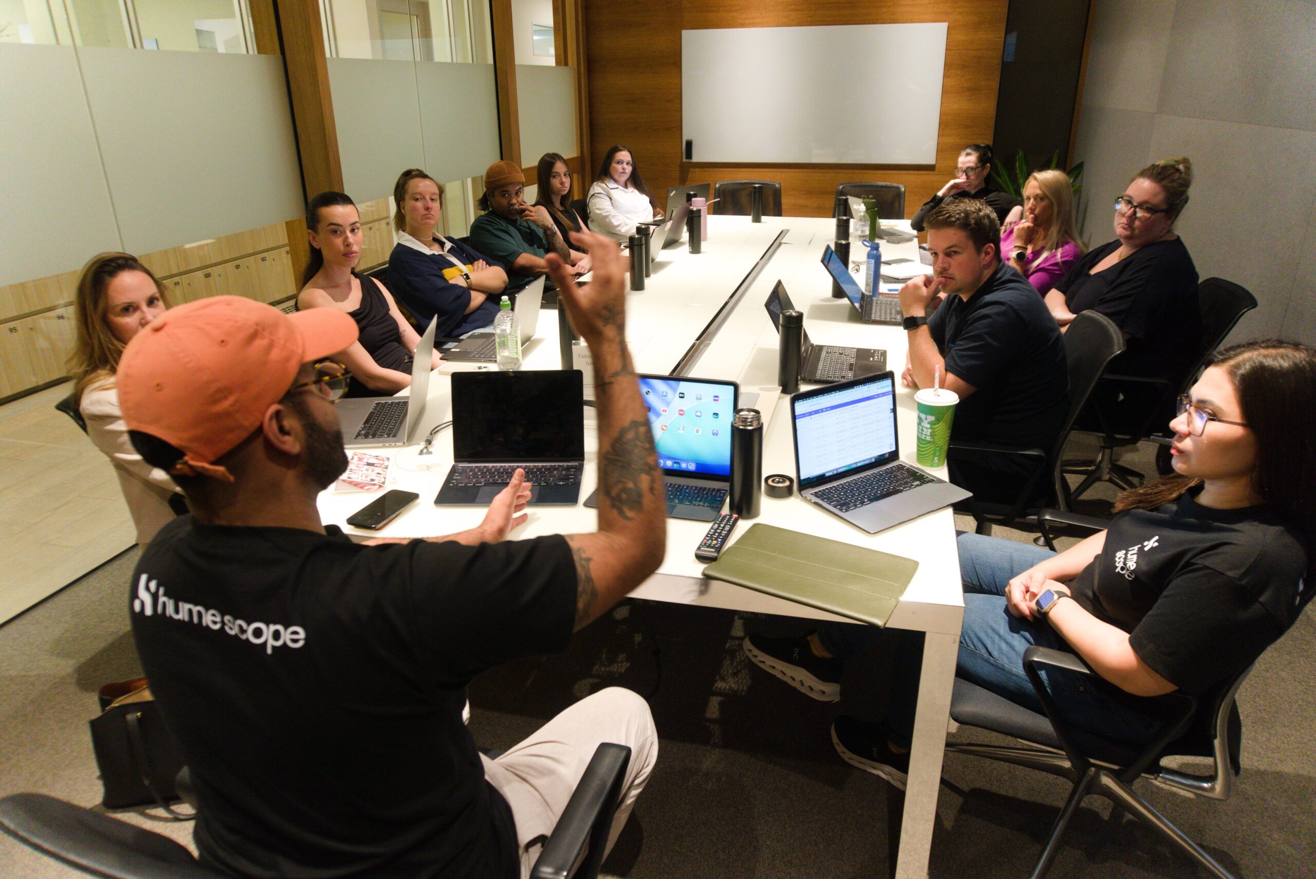 Ez running a Hume Scope team training session with the group gathered around the table
